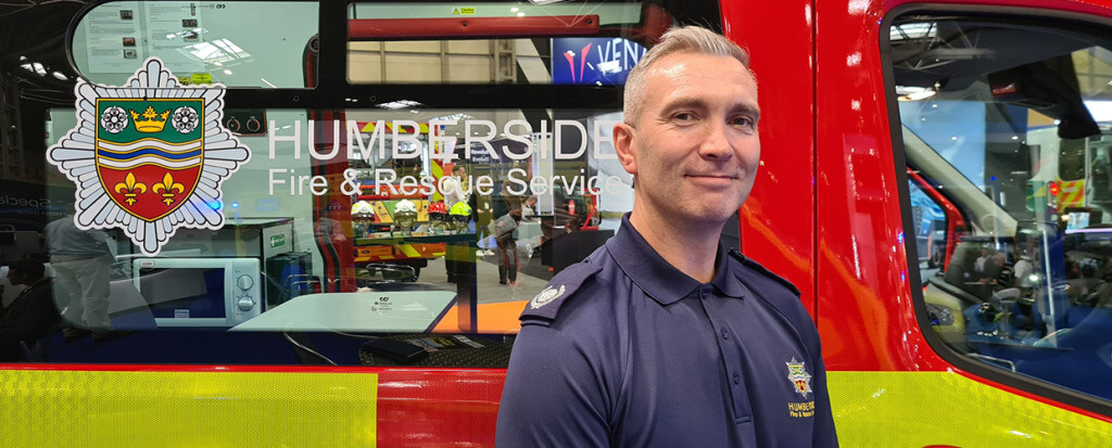 A firefighter standing in front of an firetruck