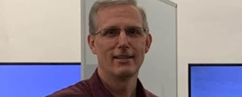 A profile picture of a man with glasses