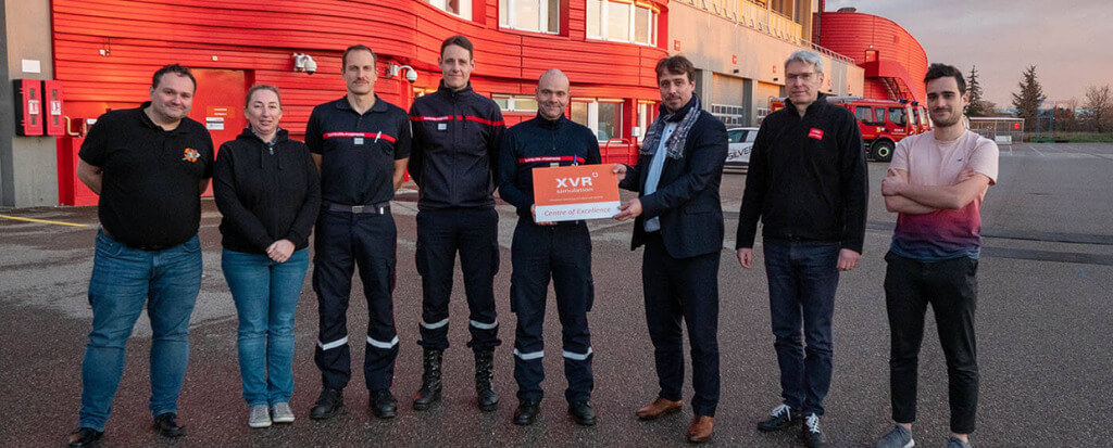 Eight men standing side by side, with one man holding an XVR plate