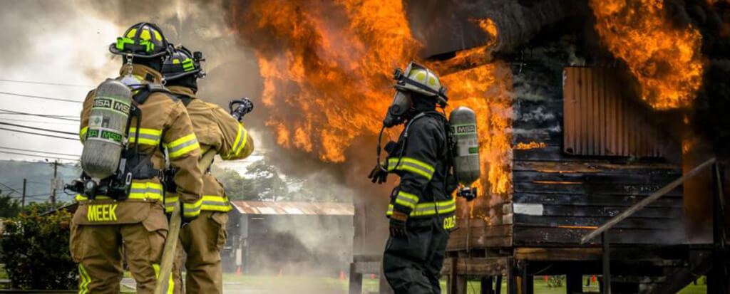 Firefighters trying to extinguish a large fire