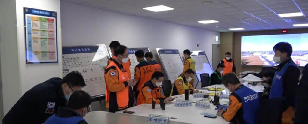 Training room with man wearing orange and blue training vests