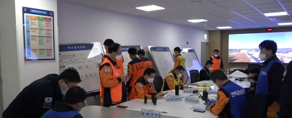 Training room with man wearing orange and blue training vests
