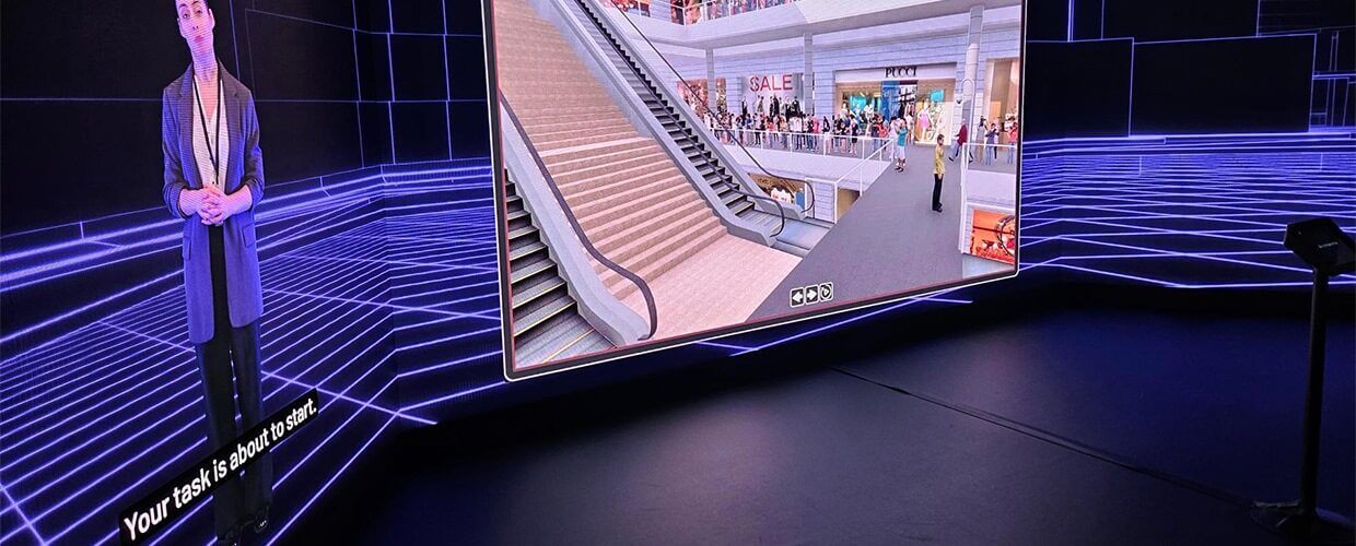 A virtual female presenting XVR on a large screen in a blue-themed room
